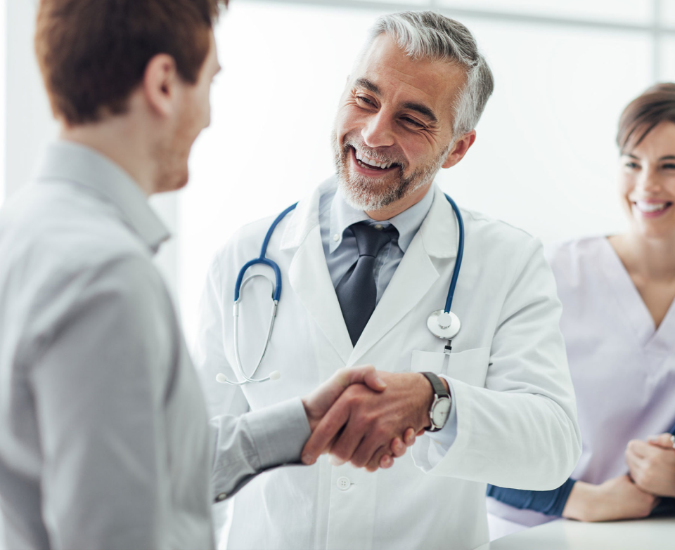 doctor congratulating men