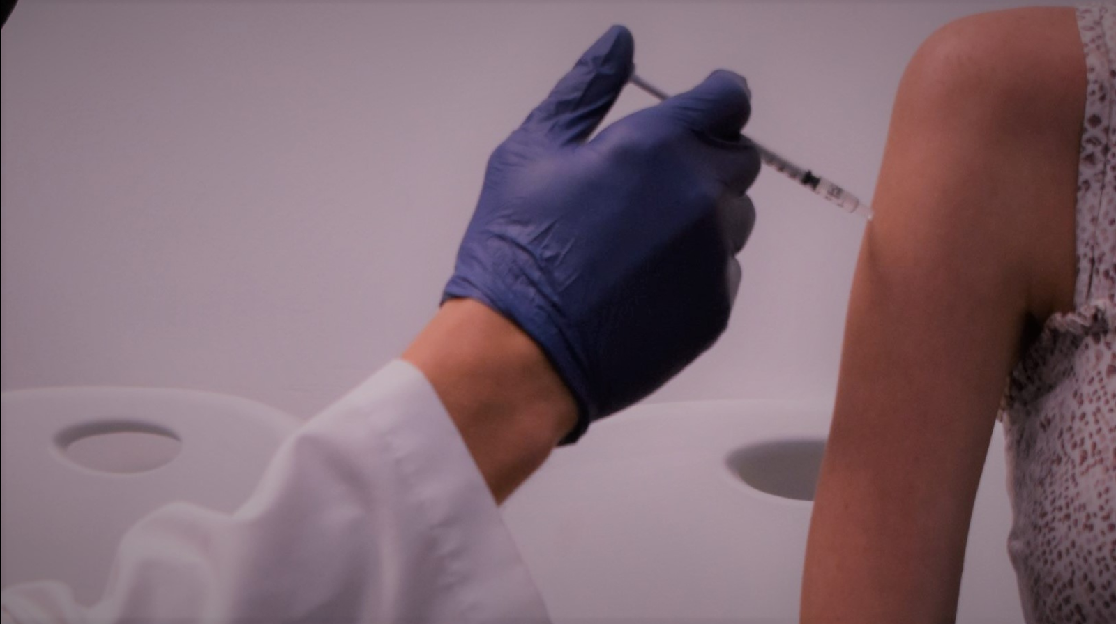 Doctor giving covid 19 vaccine to patient